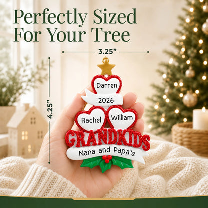 Size guide: the personalized grandkids 3 hearts christmas ornament is 3.25 in wide by 4.25 in tall, shown in hand