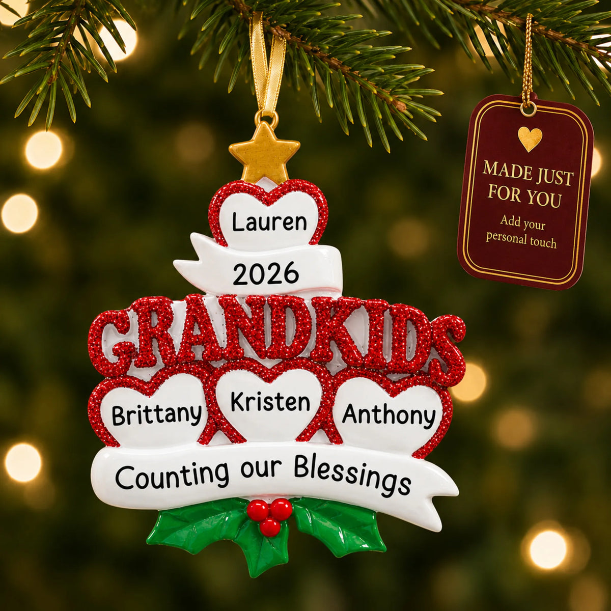 Grandkids 4 hearts christmas ornament hanging on a lit Christmas tree with a Made Just For You gift tag