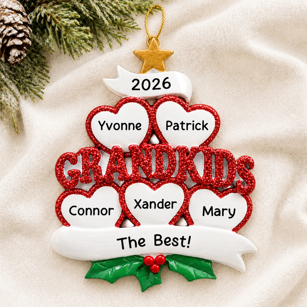 Personalized grandkids 5 hearts christmas ornament laid on a soft white knit blanket