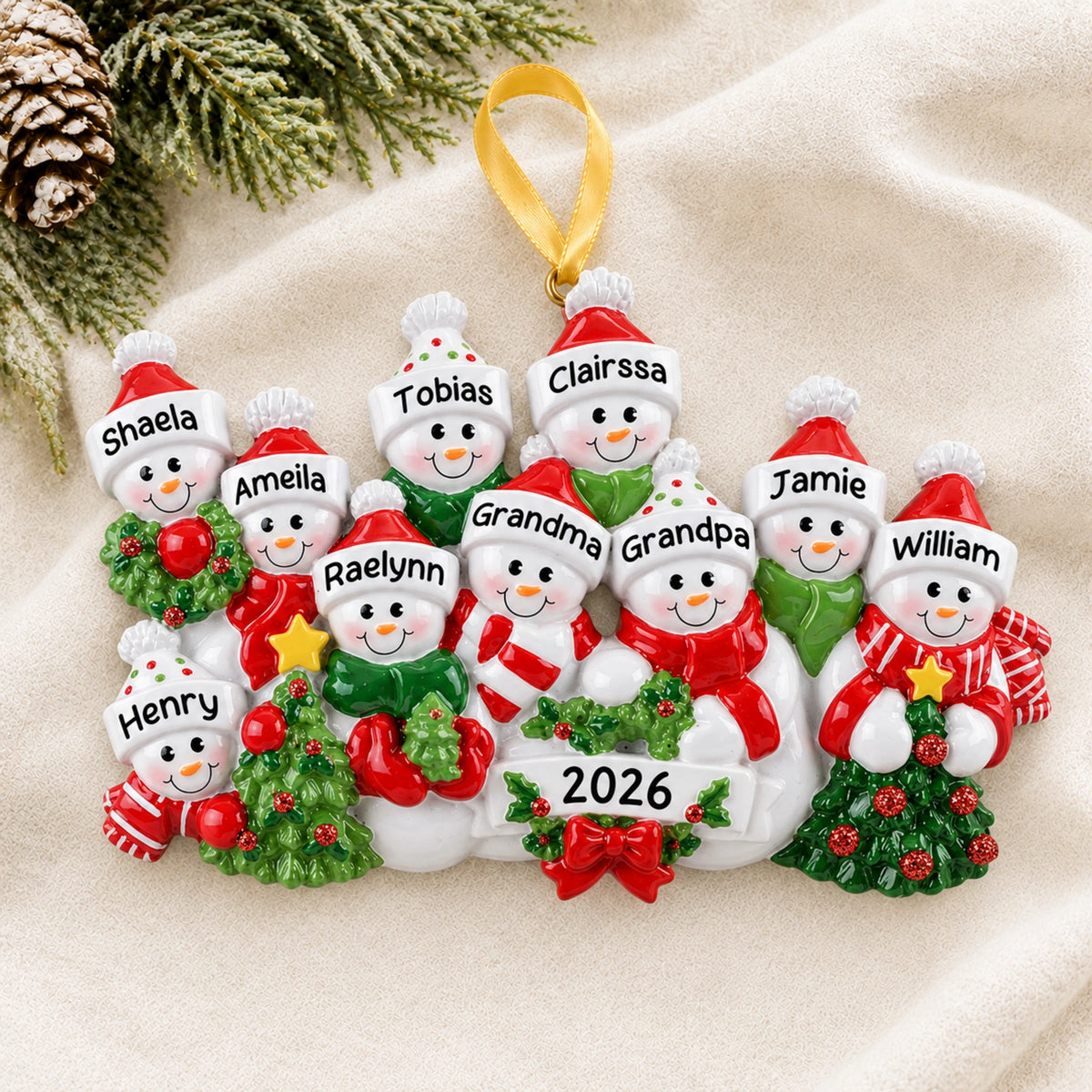 Personalized snowman family of 10 Christmas ornament hanging on a tree branch with names and 2026