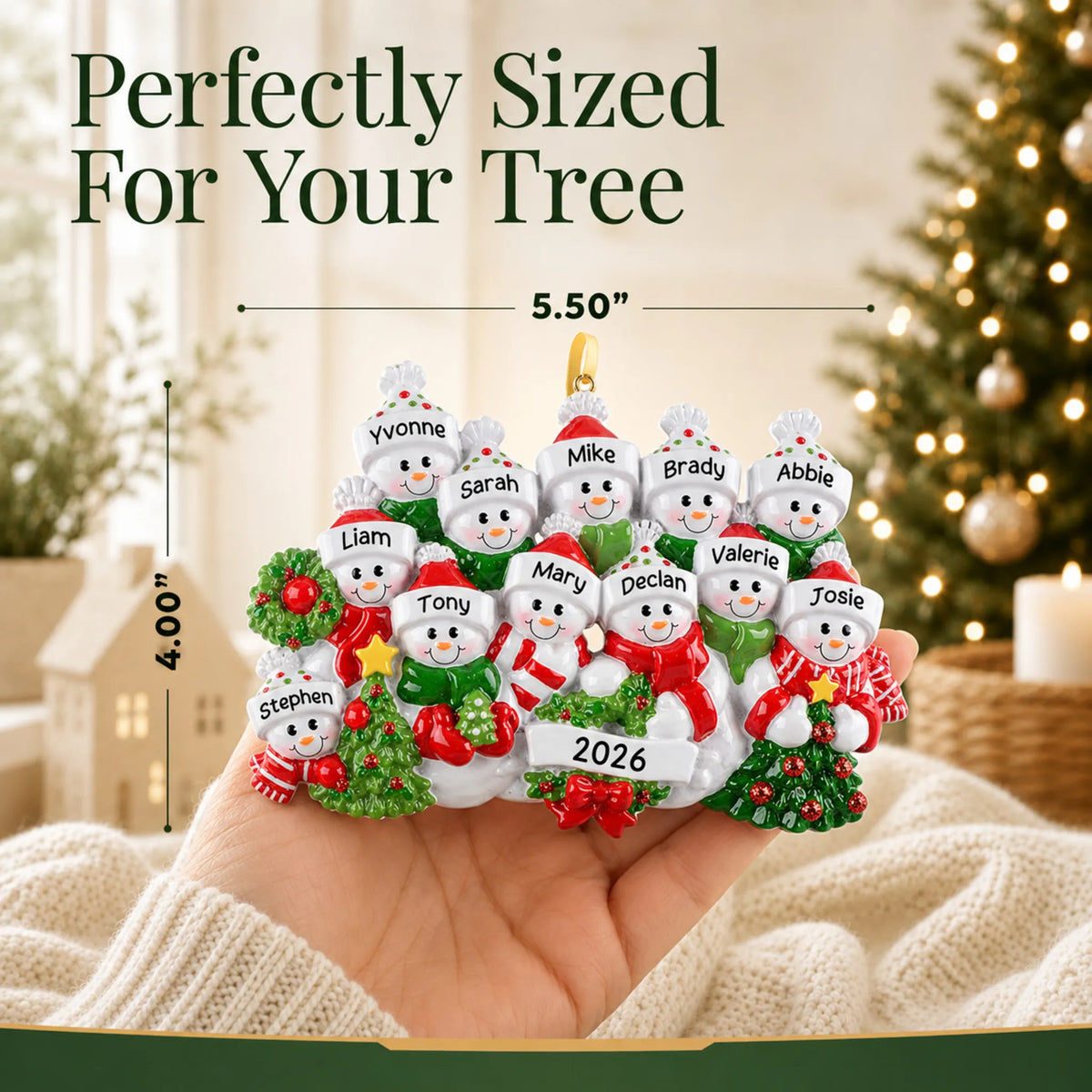 Size guide: the personalized snowman family of 12 christmas ornament is 5.50 in wide by 4.00 in tall, shown in hand
