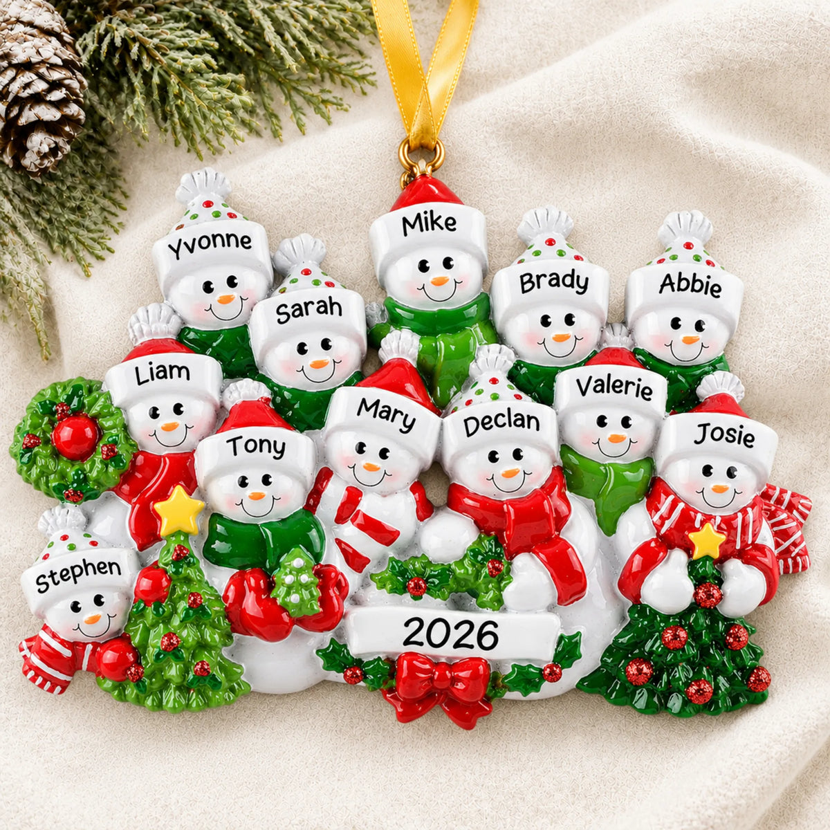 Personalized snowman family of 12 christmas ornament laid on a soft white knit blanket