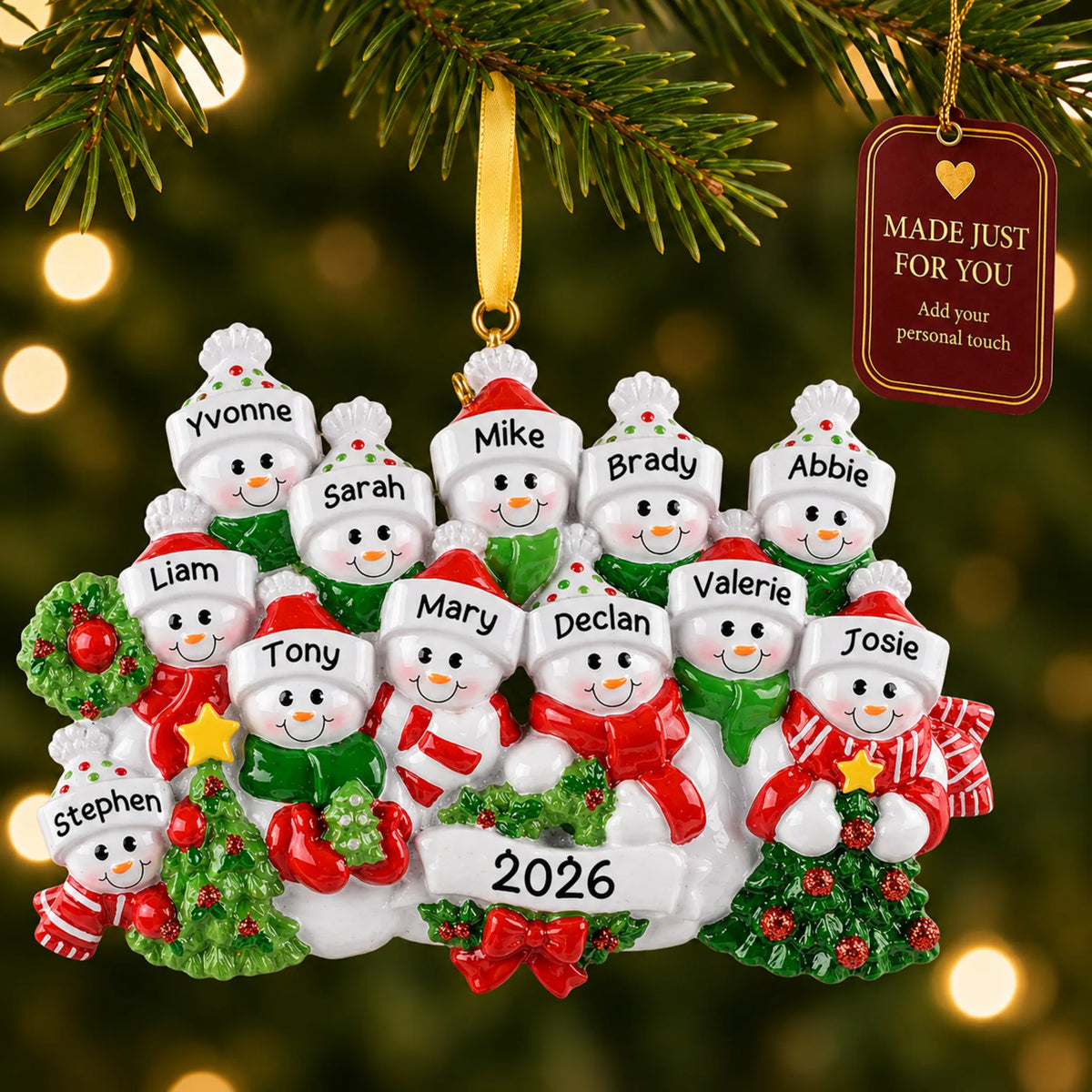Snowman family of 12 christmas ornament hanging on a lit Christmas tree with a Made Just For You gift tag