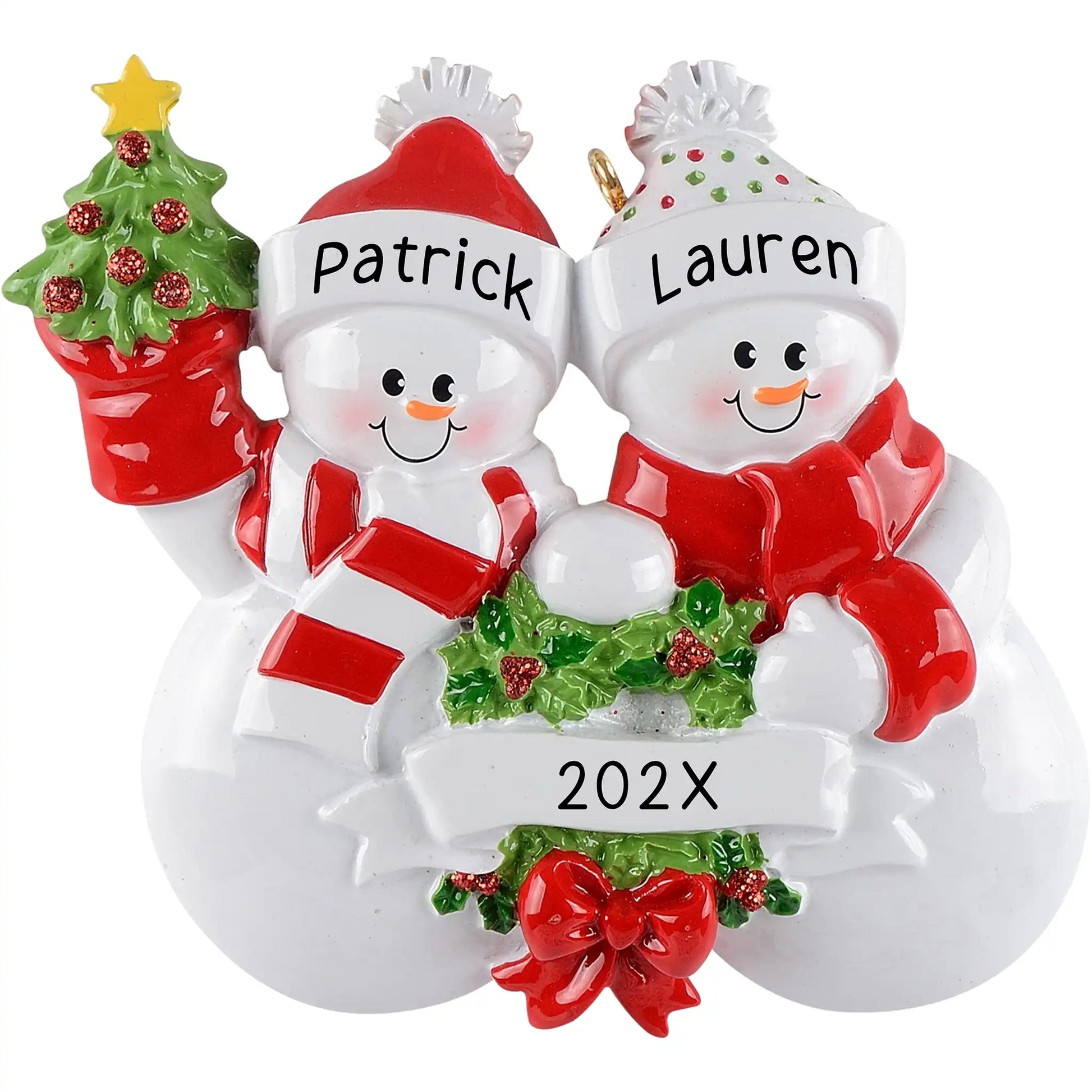 Personalized Christmas ornament featuring a snowman couple in red and white winter hats, holding a miniature Christmas tree and garland, with a blank white banner for custom name engraving.