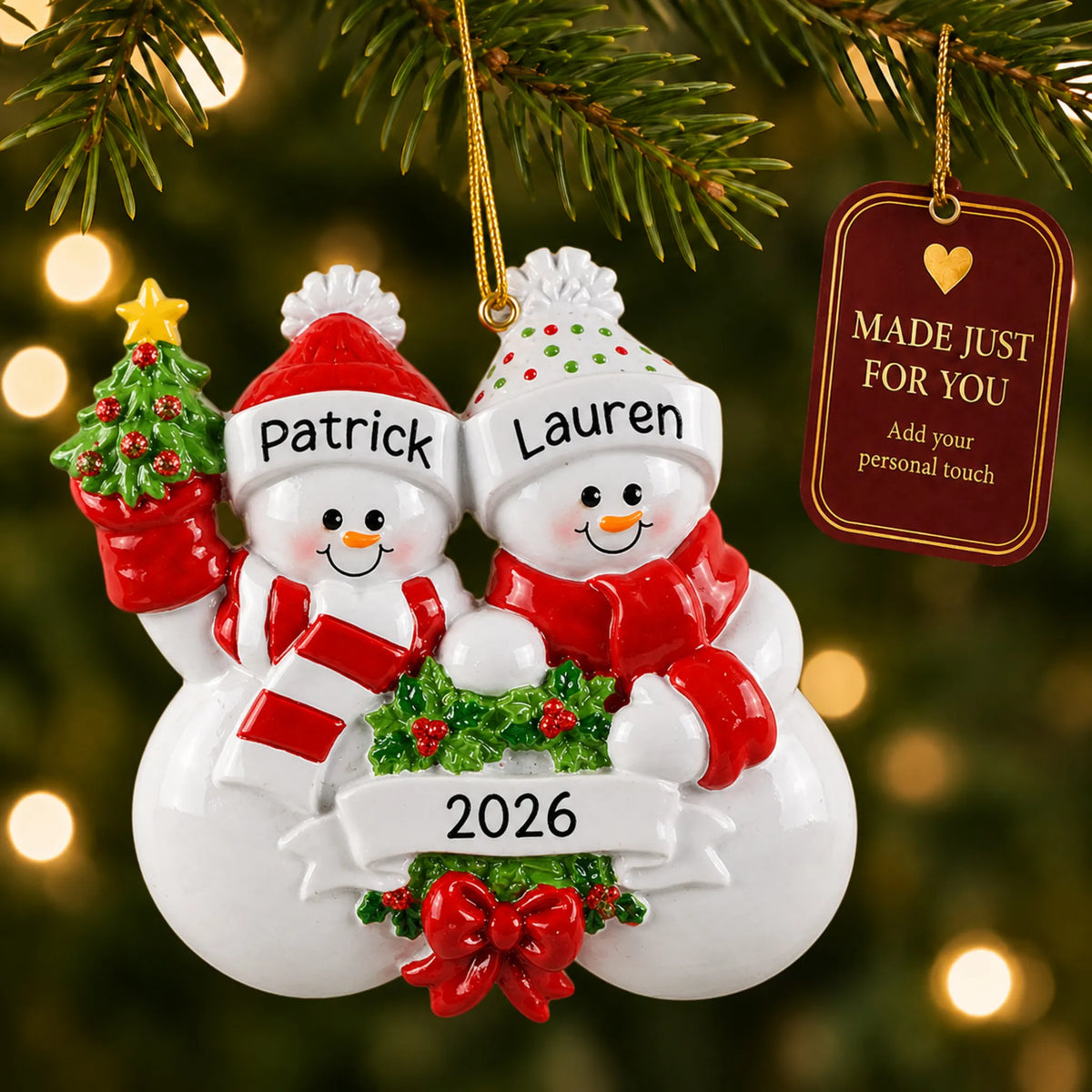 Snowman couple christmas ornament hanging on a lit Christmas tree with a Made Just For You gift tag