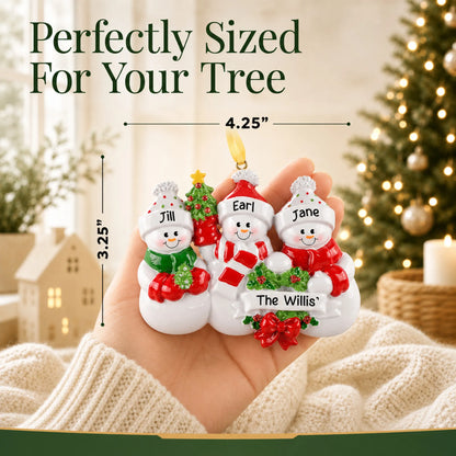 Size guide: the personalized snowman family of 3 christmas ornament is 4.25 in wide by 3.25 in tall, shown in hand