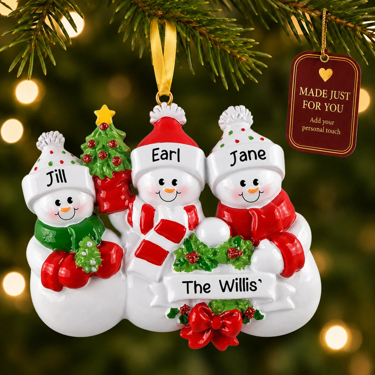 Snowman family of 3 christmas ornament hanging on a lit Christmas tree with a Made Just For You gift tag