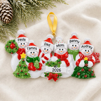 Personalized snowman family of 6 christmas ornament laid on a soft white knit blanket