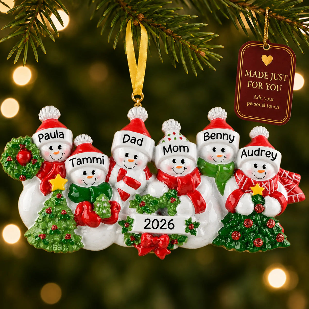 Snowman family of 6 christmas ornament hanging on a lit Christmas tree with a Made Just For You gift tag