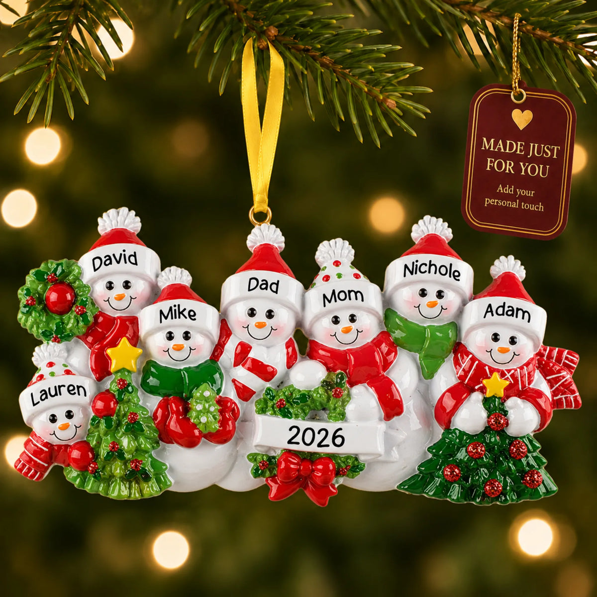Snowman family of 7 christmas ornament hanging on a lit Christmas tree with a Made Just For You gift tag