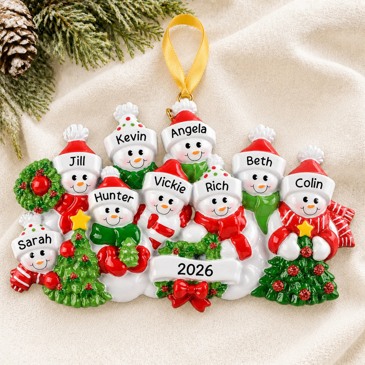 Personalized snowman family of 9 christmas ornament laid on a soft white knit blanket