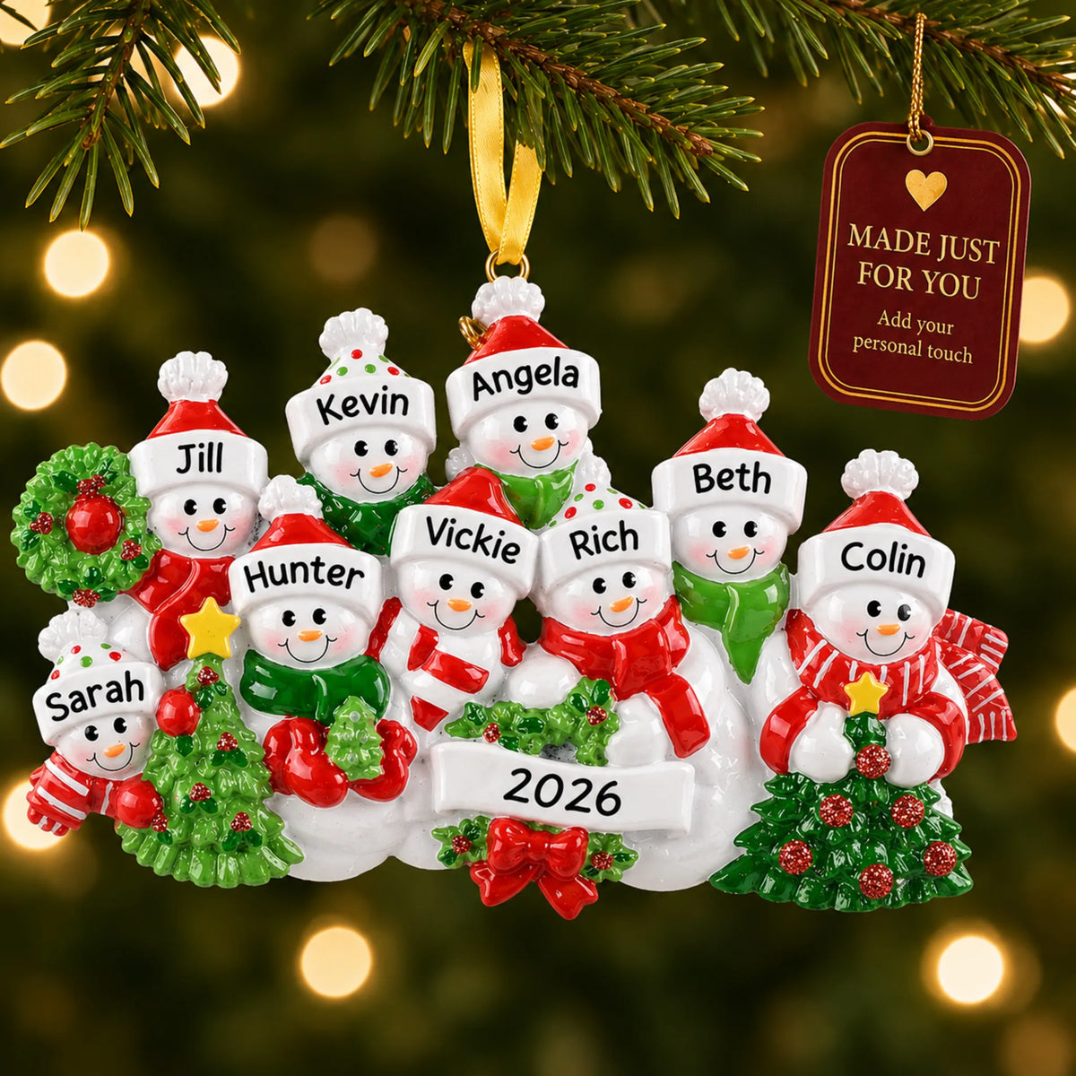 Snowman family of 9 christmas ornament hanging on a lit Christmas tree with a Made Just For You gift tag