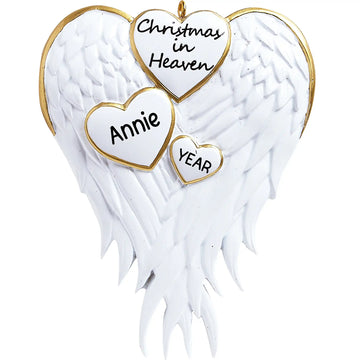 Personalized Christmas in Heaven memorial ornament with white angel wings, gold trim and three hearts, customizable with name and year