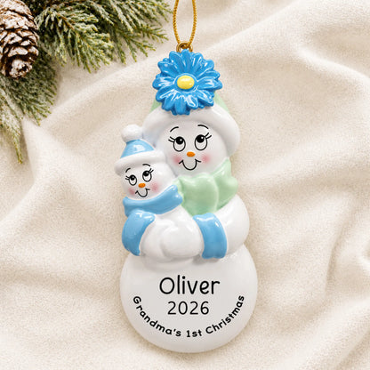 Personalized grandma's 1st christmas ornament laid on a soft white knit blanket