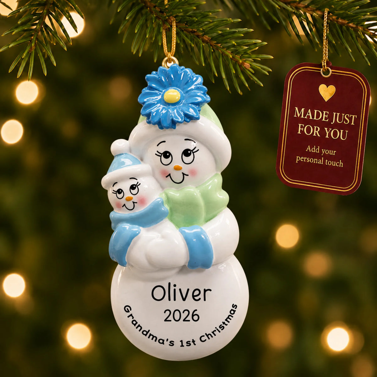 Grandma's 1st christmas ornament hanging on a lit Christmas tree with a Made Just For You gift tag