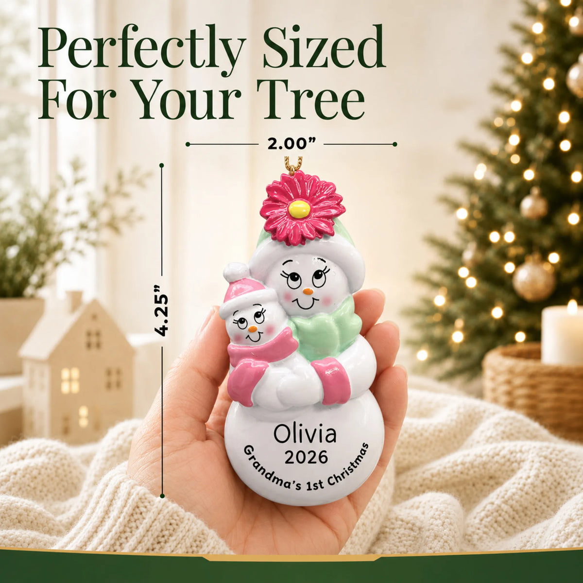 Size guide: the personalized pink grandma's 1st christmas ornament shown in hand next to a Christmas tree