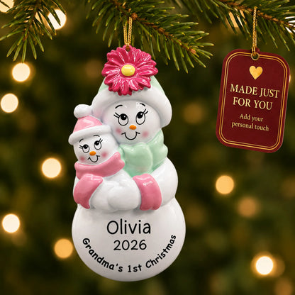 Pink grandma's 1st christmas ornament hanging on a lit Christmas tree with a Made Just For You gift tag