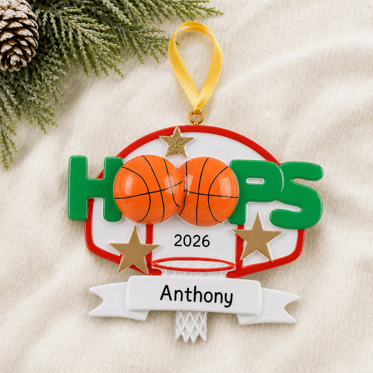 Personalized basketball hoops christmas ornament laid on a soft white knit blanket