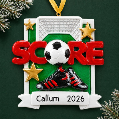 Personalized soccer score christmas ornament on a dark green pine background