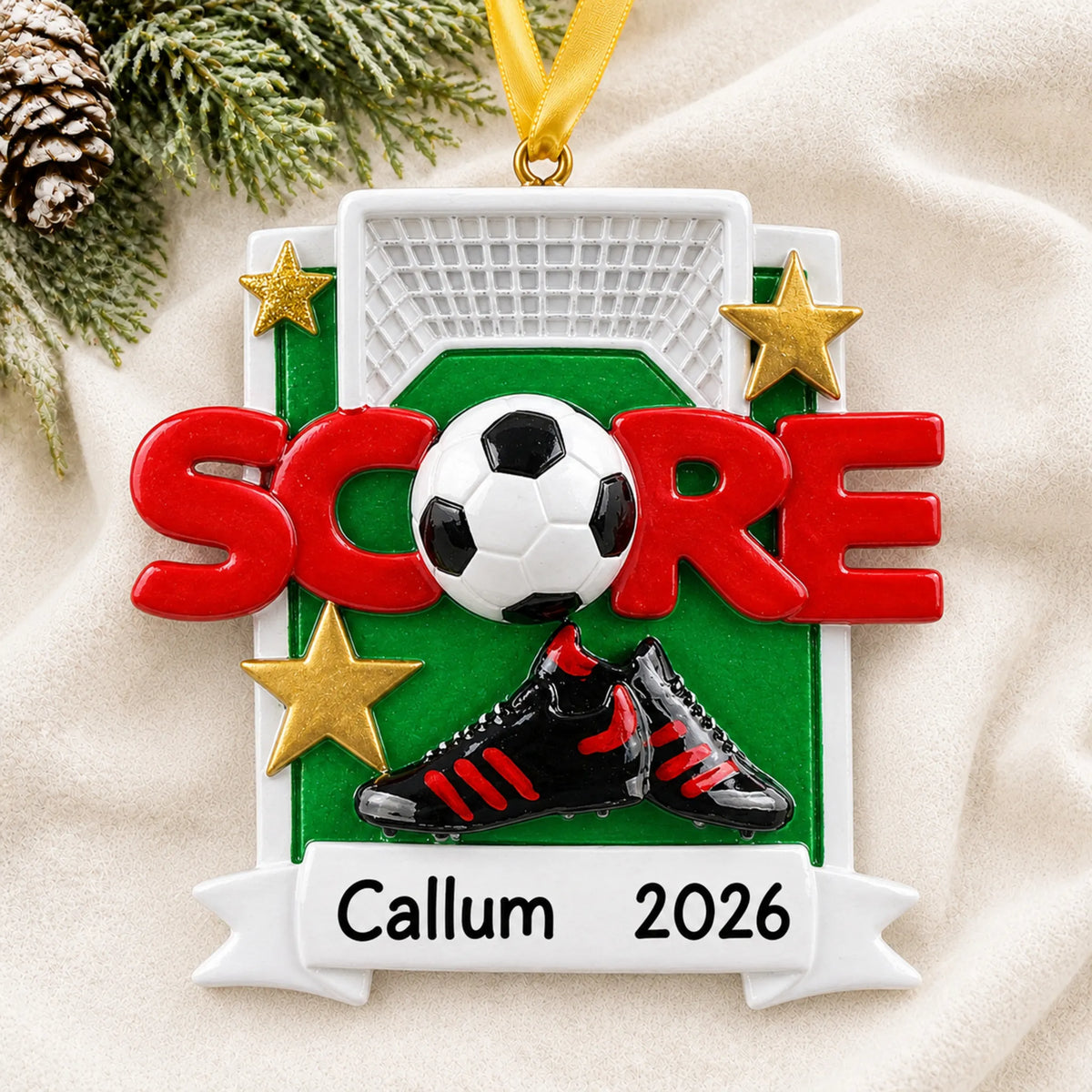 Personalized soccer score christmas ornament laid on a soft white knit blanket