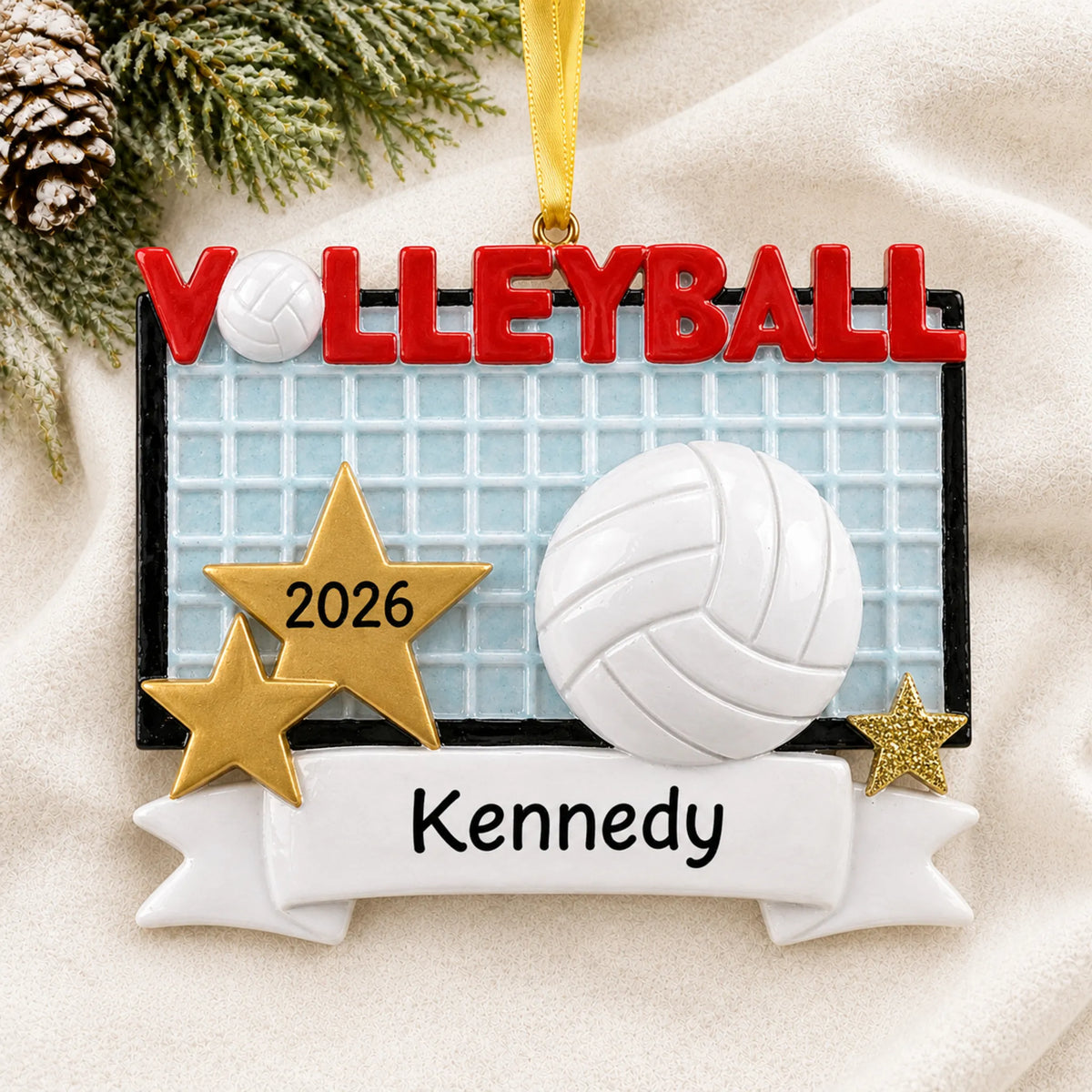 Personalized volleyball banner christmas ornament laid on a soft white knit blanket