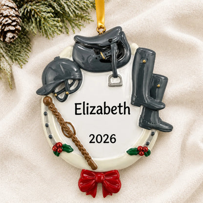 Personalized equestrian horse riding christmas ornament laid on a soft white knit blanket