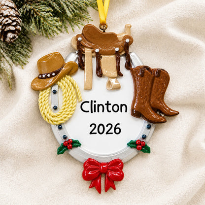 Personalized cowboy western christmas ornament laid on a soft white knit blanket