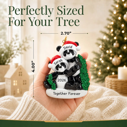 Size guide: the personalized panda couple christmas ornament is 2.70 in wide by 4.00 in tall, shown in hand