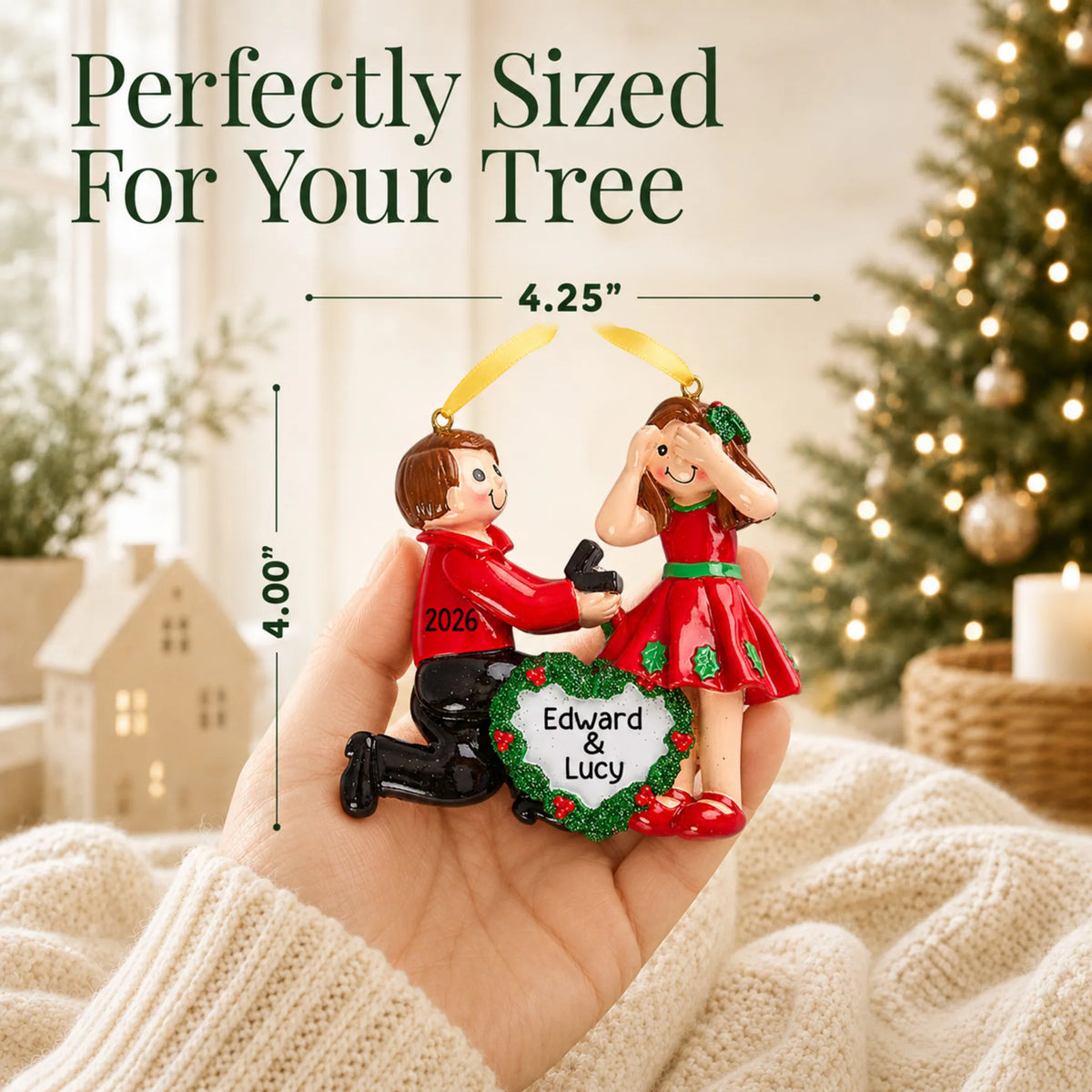 Size guide: the personalized Proposing Couple christmas ornament is 4.25 in wide by 4.00 in tall, shown in hand
