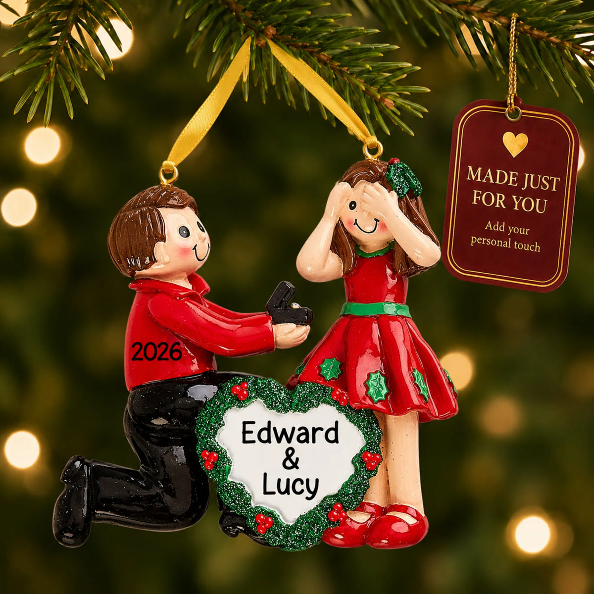 Proposing Couple christmas ornament hanging on a lit Christmas tree with a Made Just For You gift tag