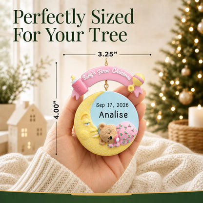 Size guide: the personalized pink baby's 1st christmas moon ornament is 3.25 in wide by 4.00 in tall, shown in hand