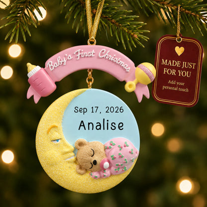 Pink baby's 1st christmas moon ornament hanging on a lit Christmas tree with a Made Just For You gift tag