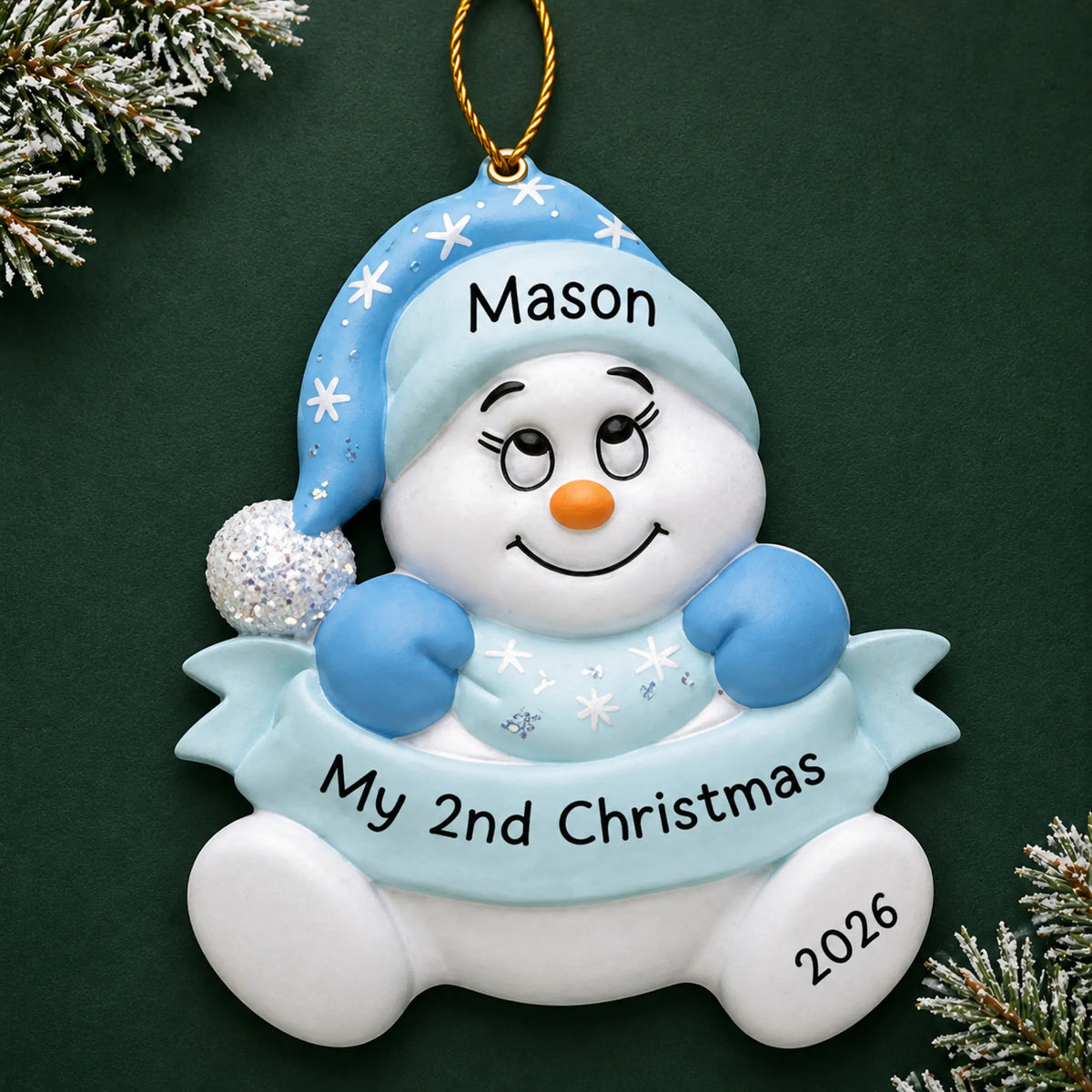 Personalized baby boy 2nd christmas snowman ornament on a dark green pine background