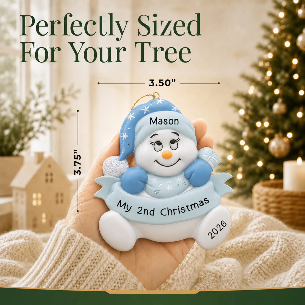 Size guide: the personalized baby boy 2nd christmas snowman ornament shown in hand next to a Christmas tree