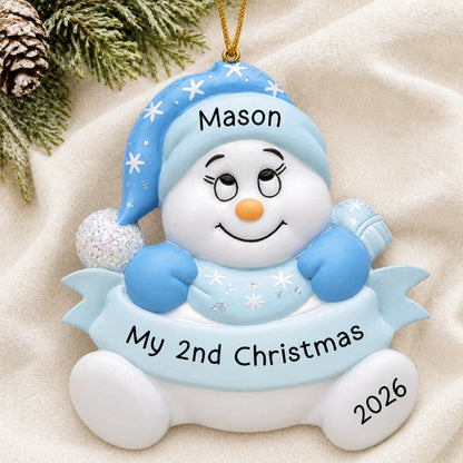 Personalized baby boy 2nd christmas snowman ornament laid on a soft white knit blanket