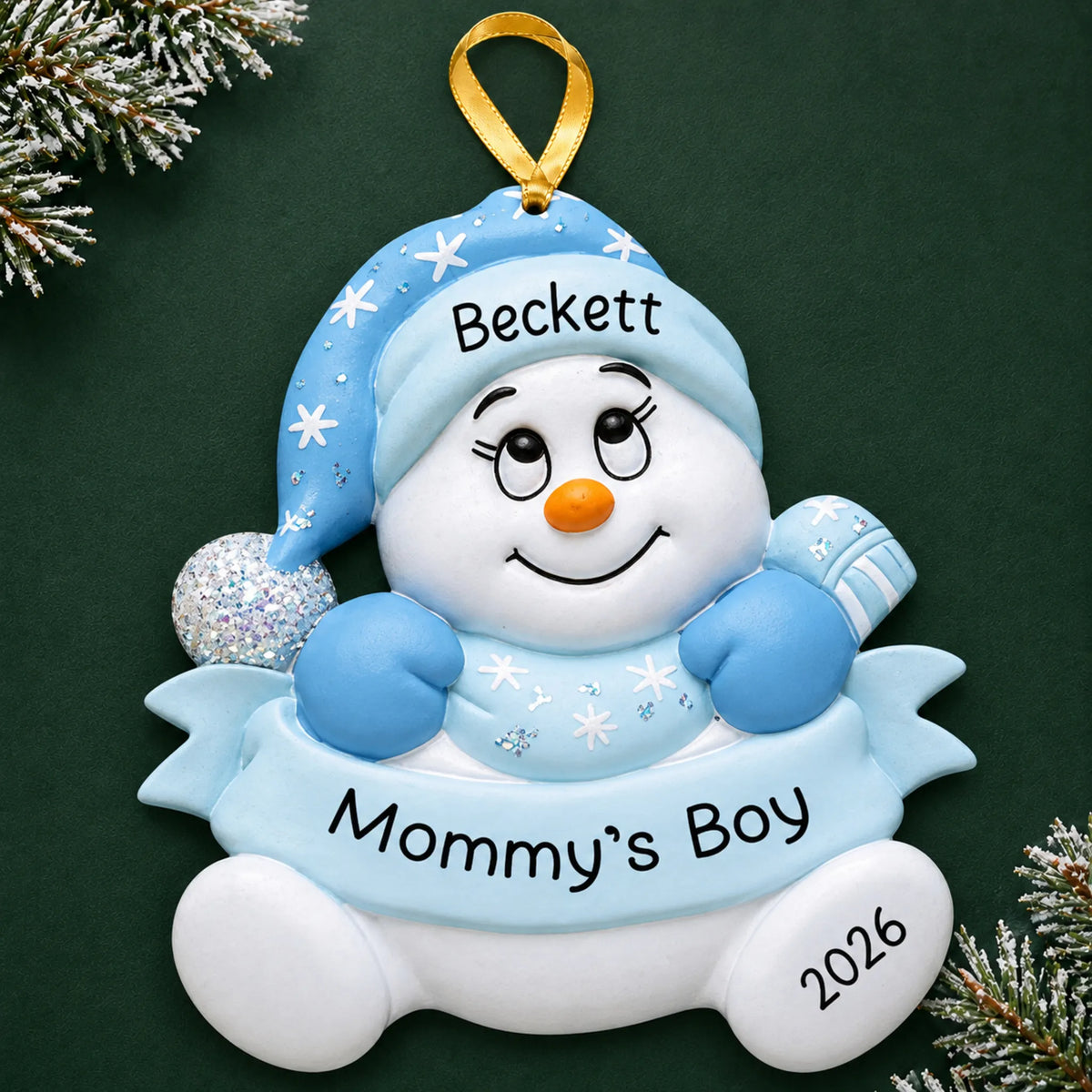 Personalized mommy's boy snowman christmas ornament on a dark green pine background