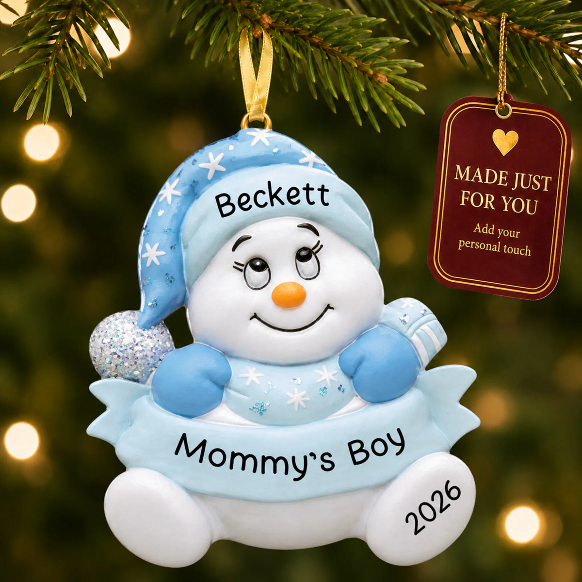 Mommy's boy snowman christmas ornament hanging on a lit Christmas tree with a Made Just For You gift tag