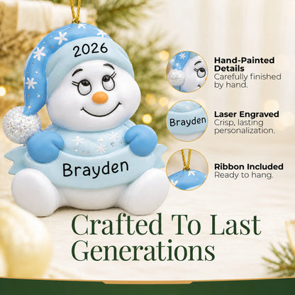 Hand-painted details and laser engraved personalization on the baby boy blue snowman christmas ornament, ribbon included