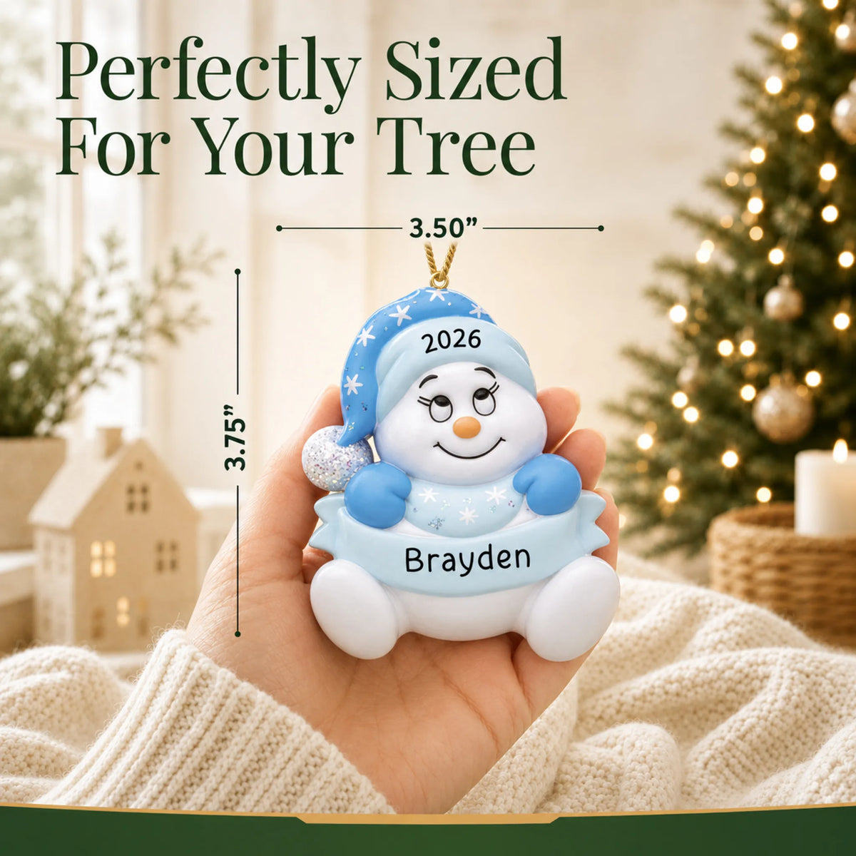 Size guide: the personalized baby boy blue snowman christmas ornament is 3.50 in wide by 3.75 in tall, shown in hand