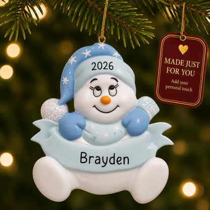 Baby boy blue snowman christmas ornament hanging on a lit Christmas tree with a Made Just For You gift tag