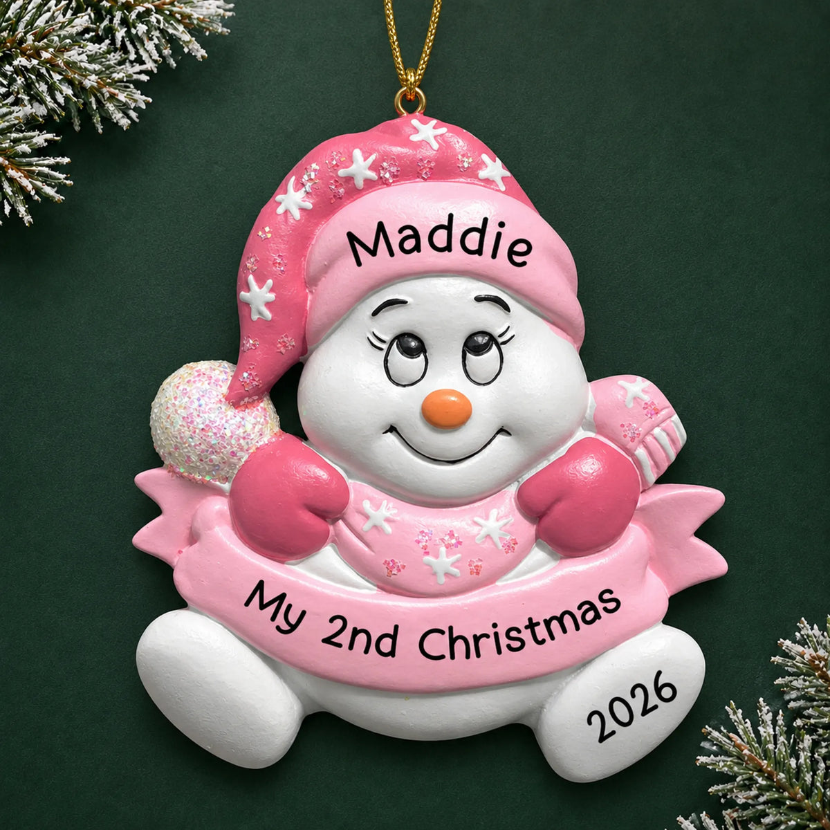 Personalized baby girl 2nd christmas snowman ornament on a dark green pine background