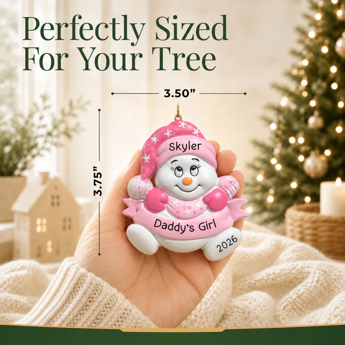 Size guide: the personalized daddy's girl snowman christmas ornament shown in hand next to a Christmas tree