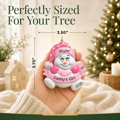 Size guide: the personalized daddy's girl snowman christmas ornament shown in hand next to a Christmas tree