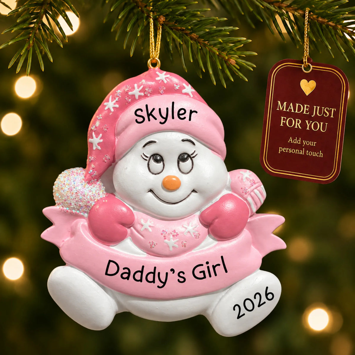 Daddy's girl snowman christmas ornament hanging on a lit Christmas tree with a Made Just For You gift tag