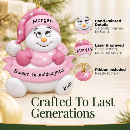 Hand-painted details and laser engraved personalization on the granddaughter pink snowman christmas ornament, ribbon included
