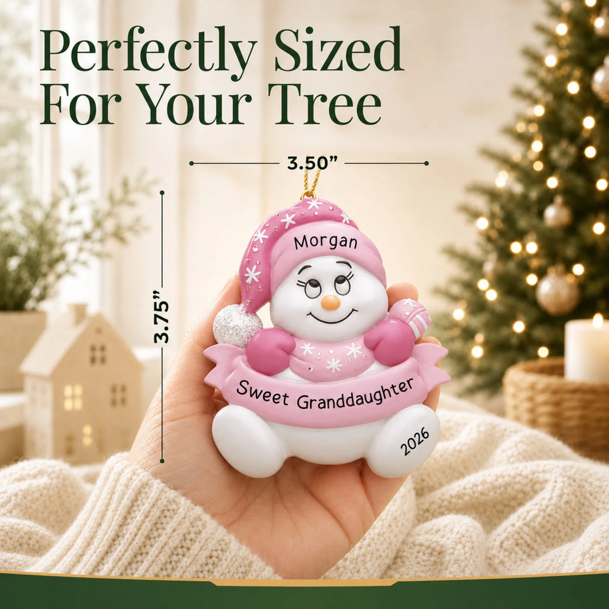 Size guide: the personalized granddaughter pink snowman christmas ornament is 3.50 in wide by 3.75 in tall, shown in hand