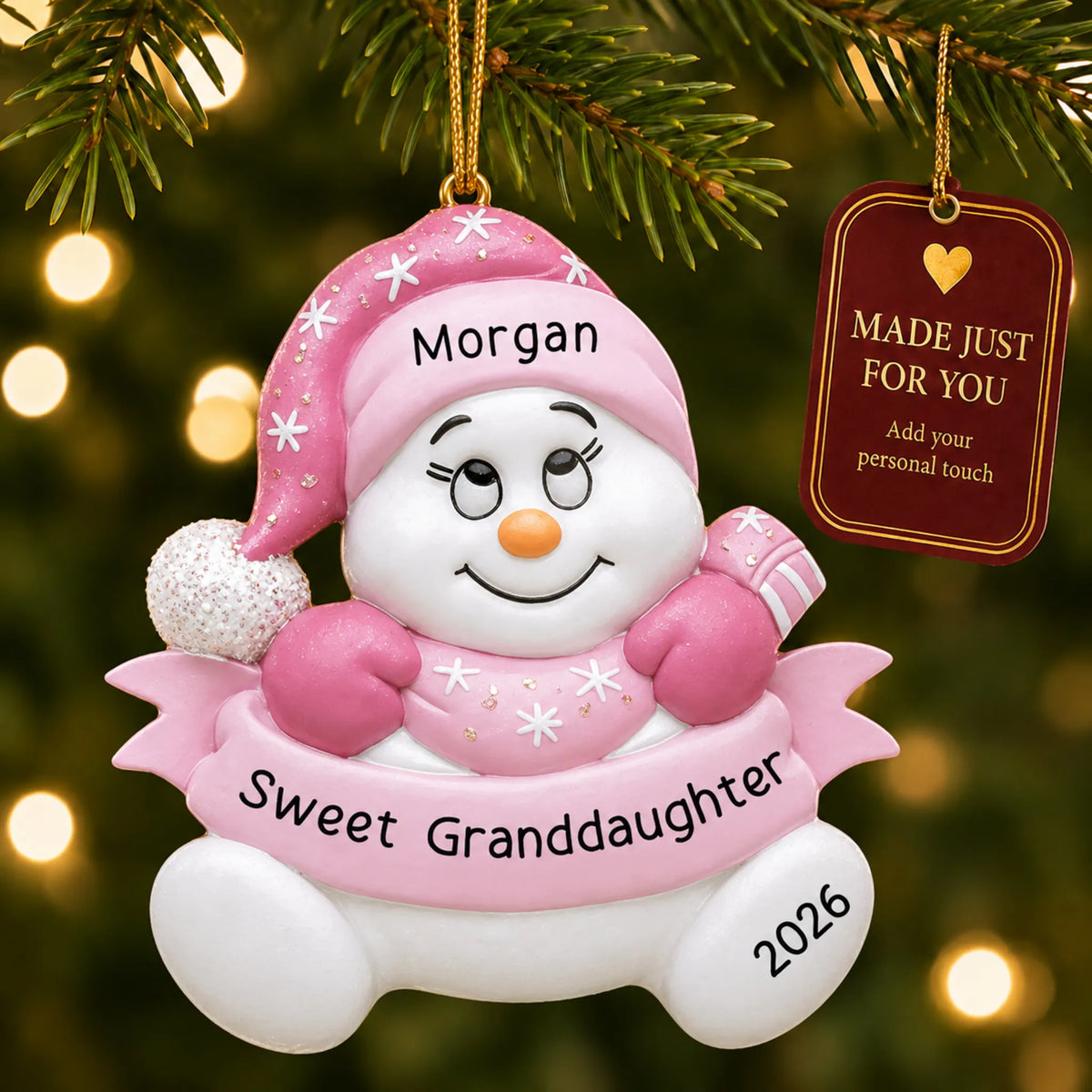 Granddaughter pink snowman christmas ornament hanging on a lit Christmas tree with a Made Just For You gift tag