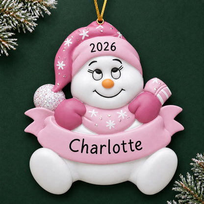 Personalized baby girl pink snowbaby christmas ornament on a dark green pine background
