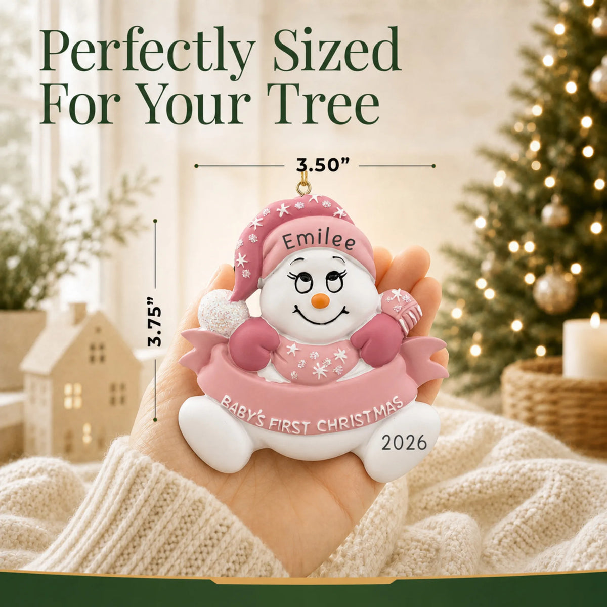 Size guide: the personalized pink baby's 1st christmas snow baby ornament is 3.50 in wide by 3.75 in tall, shown in hand