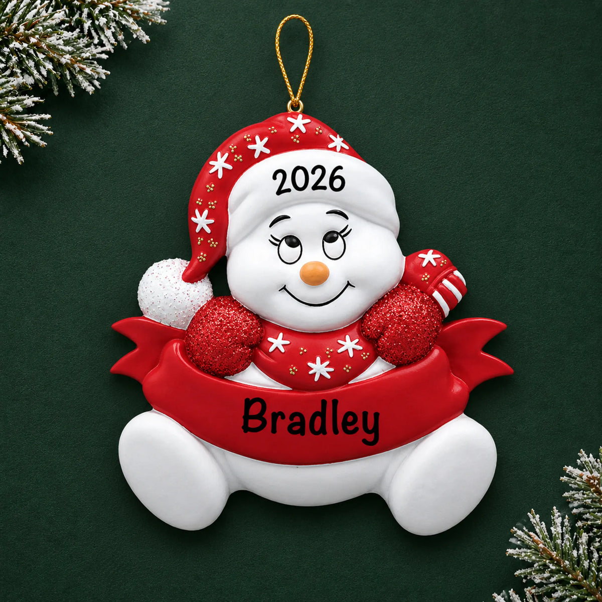 Personalized red snowbaby christmas ornament on a dark green pine background